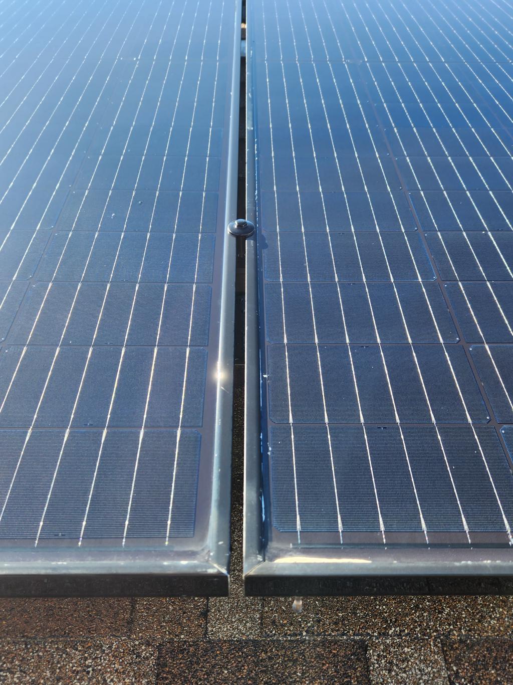 The same rooftop solar array clean and streak-free under clear Central Valley sky.