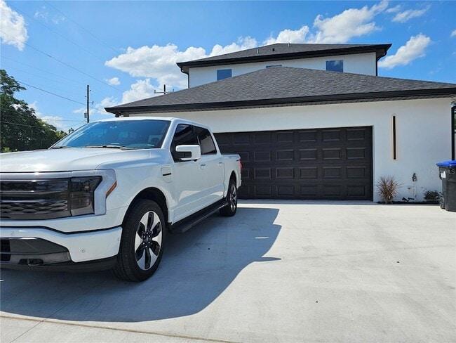 Service truck parked on a spotless, freshly cleaned concrete driveway.