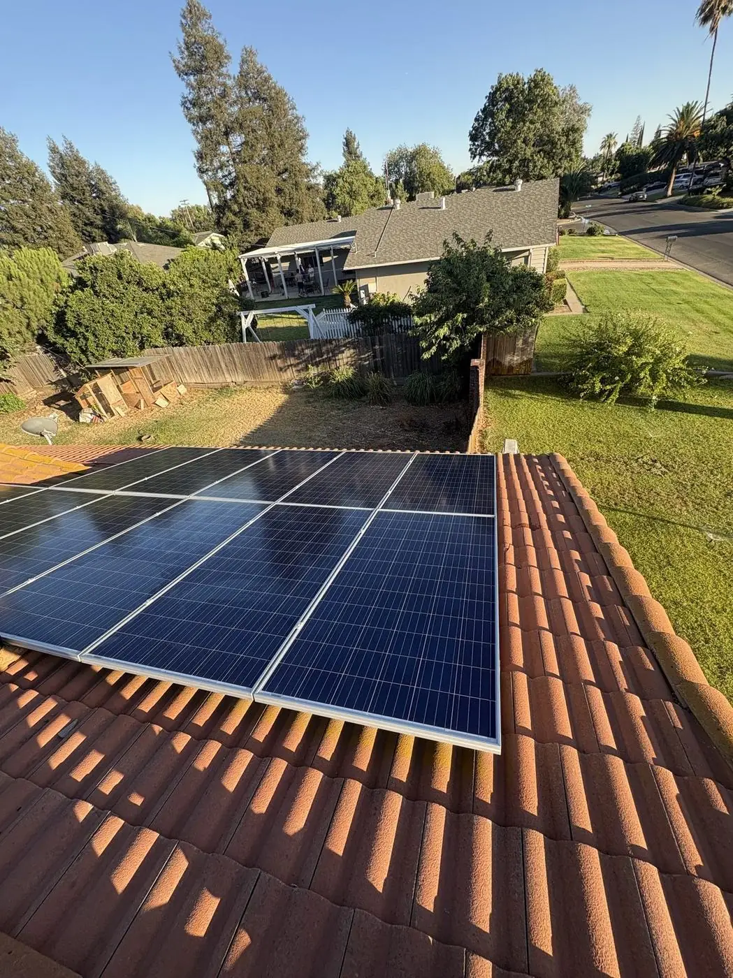 Solar panels cleaned to a bright, even finish on a terracotta tile roof.